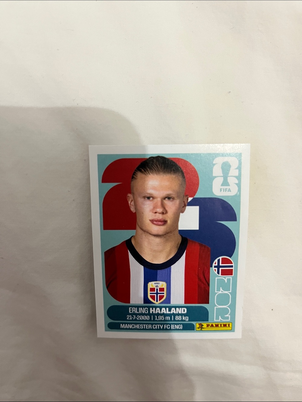 Panini sticker with red and blue accents